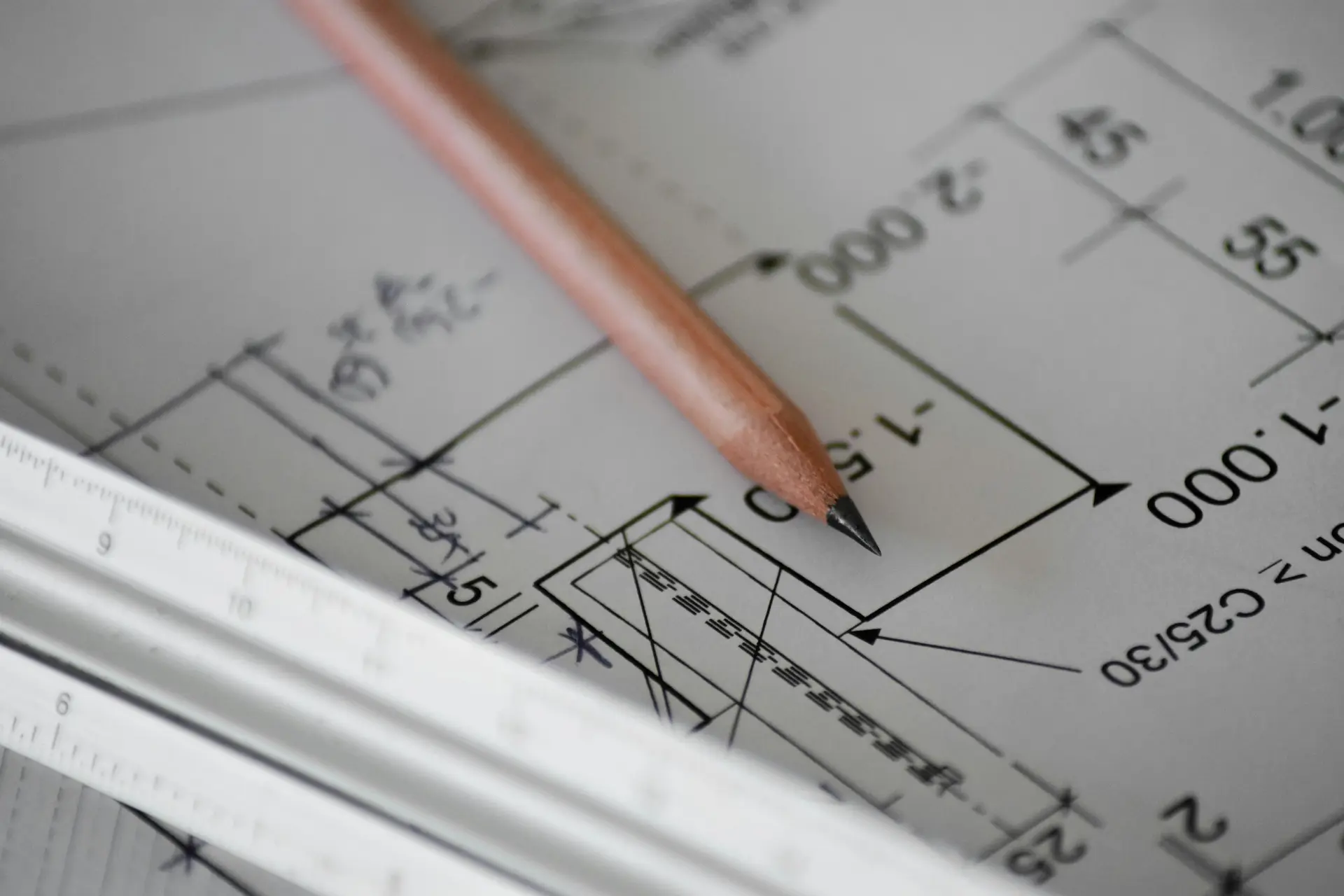Architectural drawing and blueprint detail suggesting structured project-scope discussion.