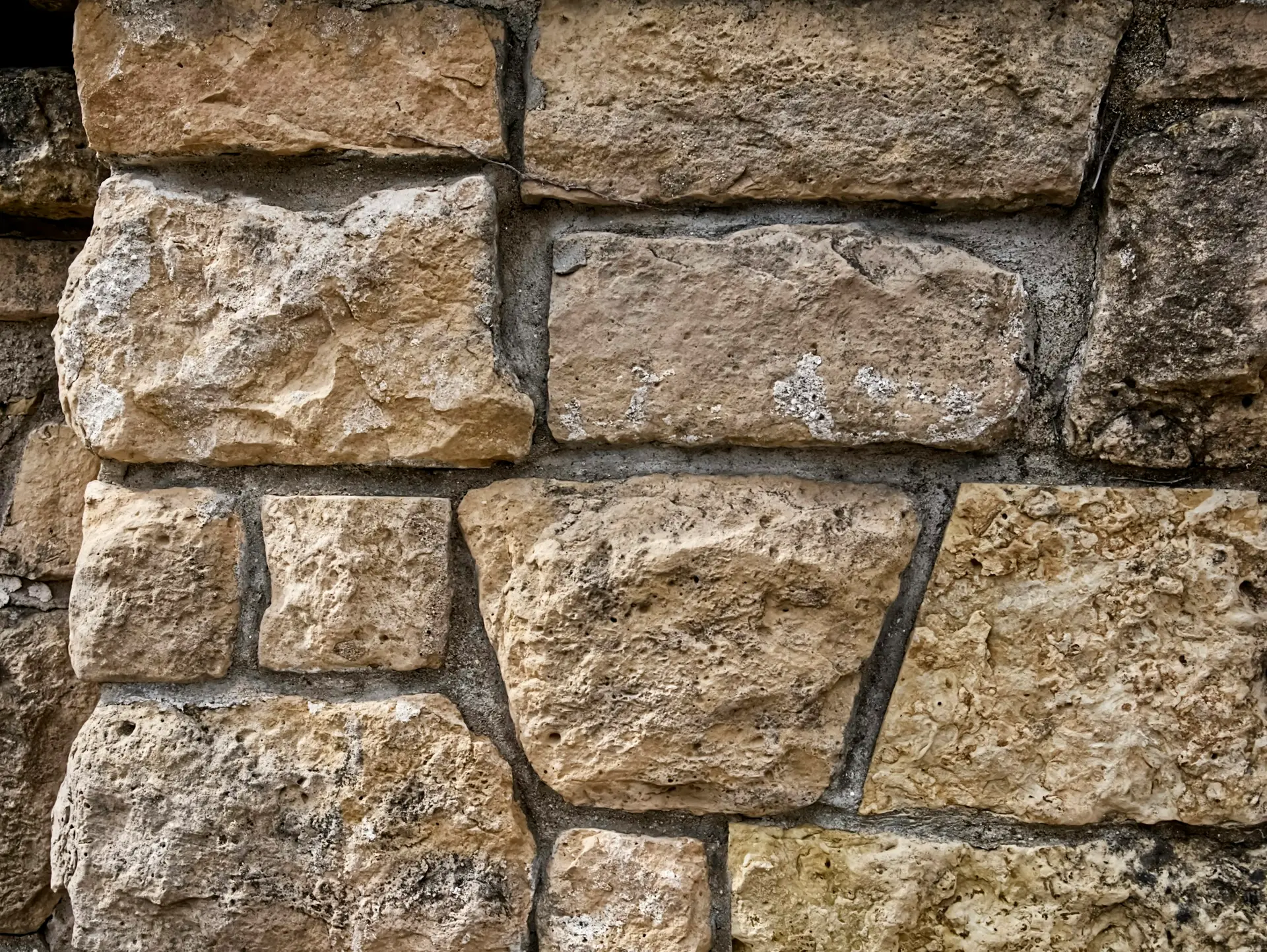 Stone masonry on a residential building, used as material atmosphere.